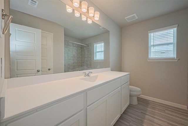 27206 Clear Breeze Dr, Katy, TX 77493 - bathroom featuring vanity, a tile shower, and wood finished floors
