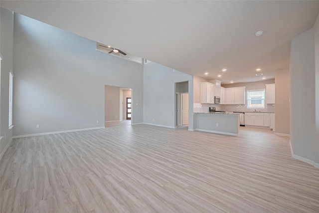 27222 Clear Breeze Dr, Katy, TX 77493 - unfurnished living room featuring light wood-style flooring and recessed lighting
