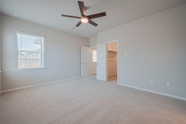 27222 Clear Breeze Dr, Katy, TX 77493 - unfurnished bedroom featuring carpet, a walk in closet, ceiling fan, and a closet