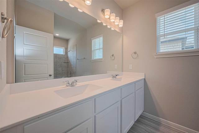 27222 Clear Breeze Dr, Katy, TX 77493 - full bathroom with double vanity, tiled shower, and wood finished floors
