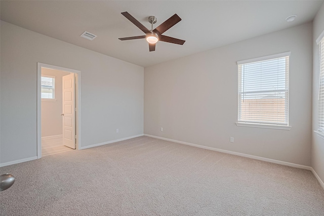 27222 Clear Breeze Dr, Katy, TX 77493 - empty room featuring a ceiling fan, light colored carpet, healthy amount of natural light, and a smoke detector
