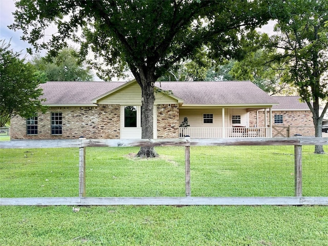 22035 Buescher Rd, Tomball, TX 77377 - single story home featuring a porch, brick siding, a front yard, and roof with shingles