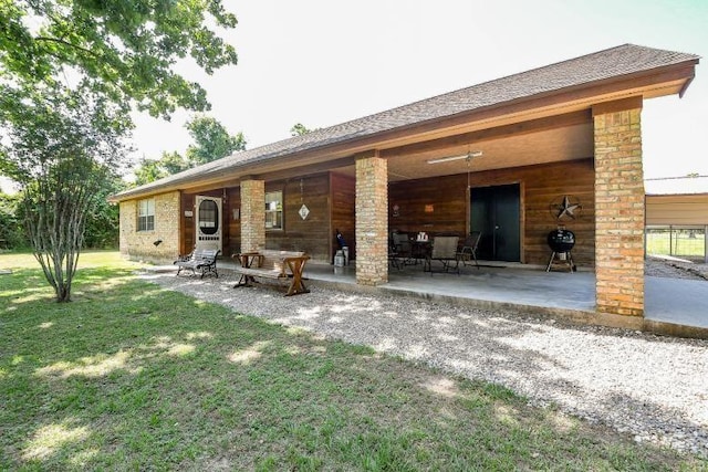 22035 Buescher Rd, Tomball, TX 77377 - back of property featuring a yard