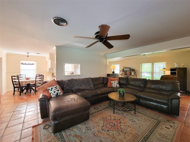 5439 Loch Lomond Dr, Houston, TX 77096 - living area with plenty of natural light, ceiling fan, light tile patterned floors, and ornamental molding