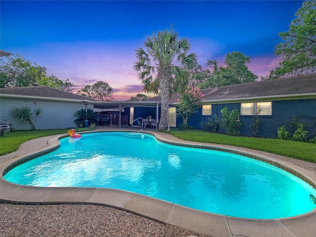 5439 Loch Lomond Dr, Houston, TX 77096 - pool at dusk featuring an outdoor pool, a patio area, and a yard