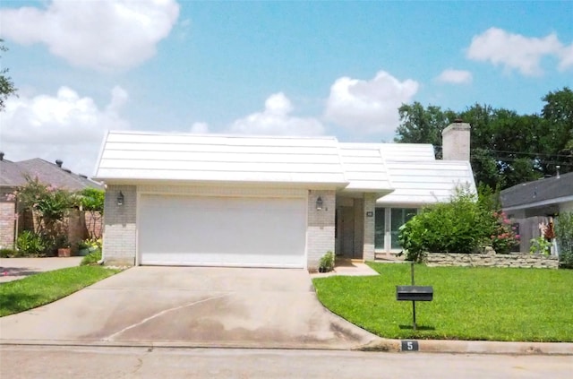 5 Tiffany Sq, Sugar Land, TX 77478 - view of front of house featuring brick siding, a garage, driveway, a front yard, and a chimney