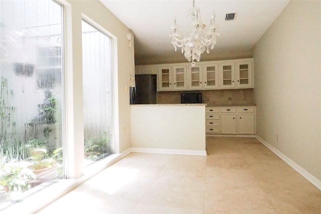5 Tiffany Sq, Sugar Land, TX 77478 - unfurnished dining area with a chandelier and baseboards