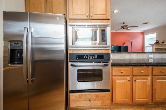 802 Lamonte, Houston, TX 77018 - kitchen featuring appliances with stainless steel finishes, a ceiling fan, and dark stone counters