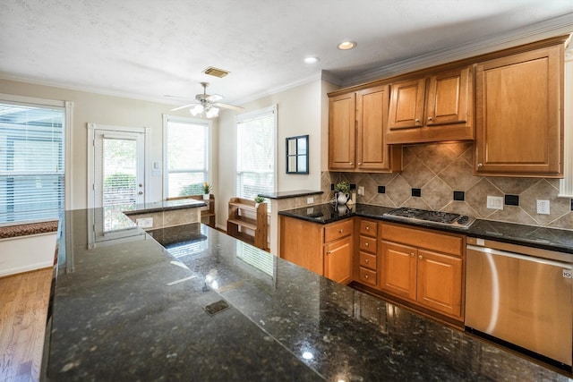 802 Lamonte, Houston, TX 77018 - kitchen with stainless steel appliances, ornamental molding, backsplash, a ceiling fan, and brown cabinets