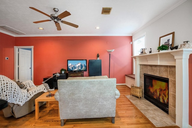802 Lamonte, Houston, TX 77018 - living area with light wood-style floors, crown molding, recessed lighting, ceiling fan, and a tiled fireplace