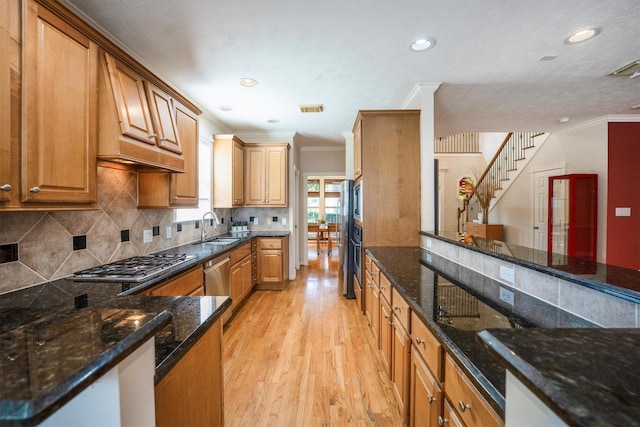 802 Lamonte, Houston, TX 77018 - kitchen with stainless steel gas cooktop, ornamental molding, light wood-style floors, dark stone counters, and tasteful backsplash