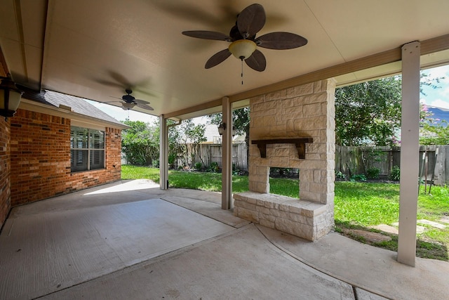 26622 Boulder Cove Ct, Katy, TX 77494 - fenced backyard featuring ceiling fan, a patio area, and an outdoor stone fireplace