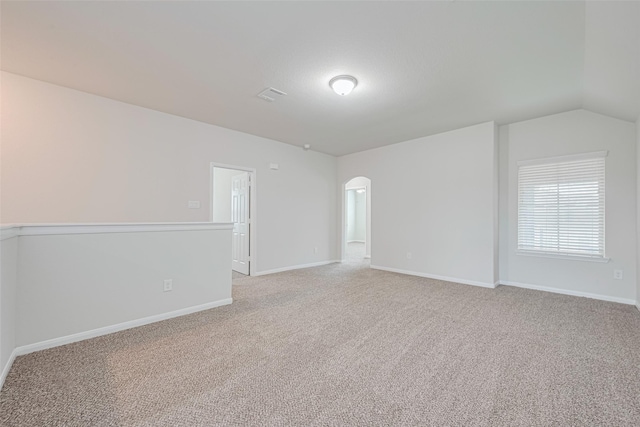 23607 Acerola Tree Ct, Katy, TX 77493 - unfurnished room featuring arched walkways, light colored carpet, and lofted ceiling