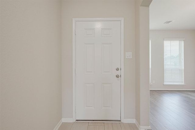 23607 Acerola Tree Ct, Katy, TX 77493 - doorway to outside featuring baseboards and light wood-style floors