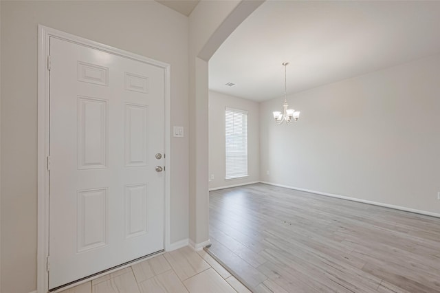 23607 Acerola Tree Ct, Katy, TX 77493 - foyer entrance featuring arched walkways, a chandelier, and light wood-style floors