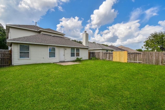 19727 Hon Ct, Katy, TX 77449 - back of property featuring a fenced backyard, a chimney, and roof with shingles
