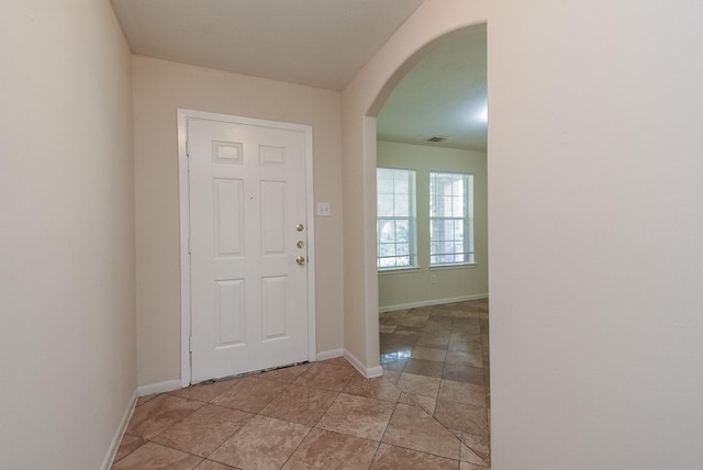19727 Hon Ct, Katy, TX 77449 - foyer with arched walkways and light tile patterned floors