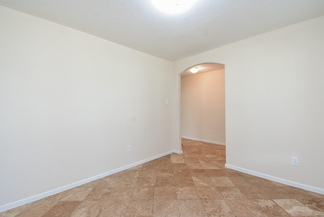 19727 Hon Ct, Katy, TX 77449 - unfurnished room with arched walkways and stone finish flooring