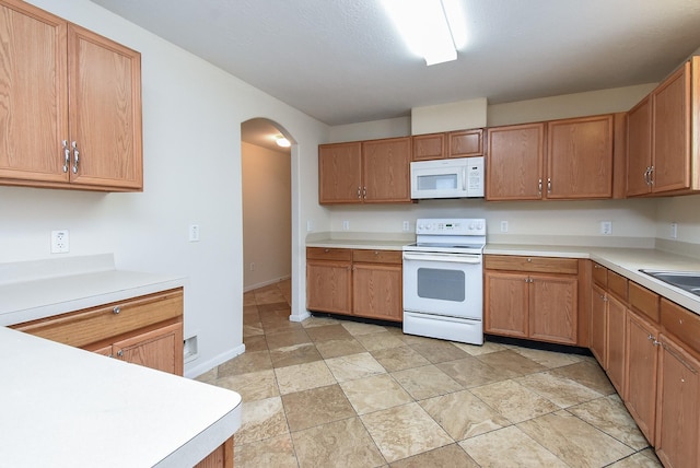 19727 Hon Ct, Katy, TX 77449 - kitchen featuring white appliances, arched walkways, and light countertops