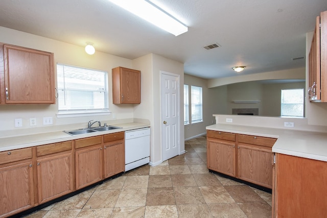 19727 Hon Ct, Katy, TX 77449 - kitchen with dishwasher, a fireplace, light countertops, a peninsula, and open floor plan