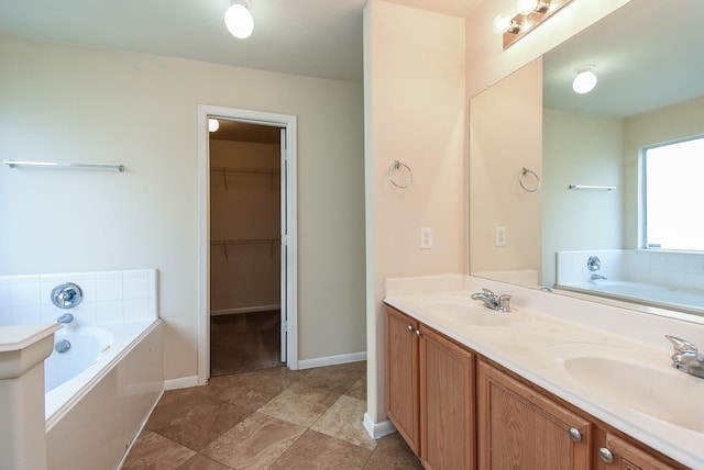 19727 Hon Ct, Katy, TX 77449 - bathroom featuring a bath, double vanity, and a walk in closet