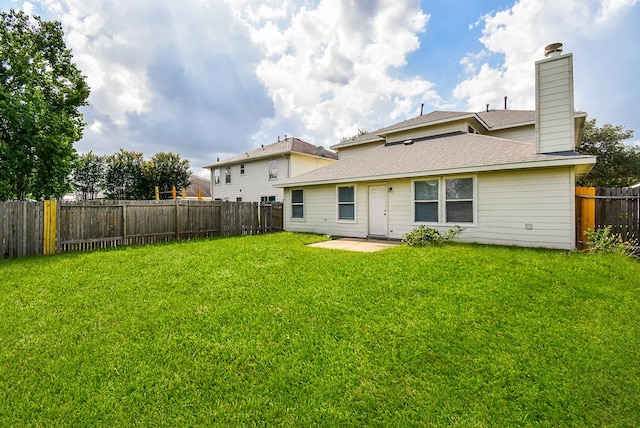 19727 Hon Ct, Katy, TX 77449 - back of house with a fenced backyard, a chimney, a patio area, and roof with shingles