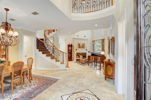 3207 Riviera Dr, Sugar Land, TX 77479 - entrance foyer with a chandelier, stairway, a towering ceiling, recessed lighting, and crown molding