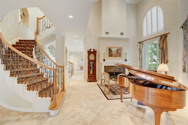 3207 Riviera Dr, Sugar Land, TX 77479 - foyer featuring arched walkways, a high ceiling, recessed lighting, ornamental molding, and stairway