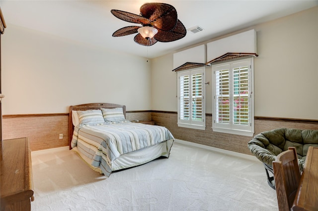 3207 Riviera Dr, Sugar Land, TX 77479 - bedroom with carpet flooring, a wainscoted wall, and ceiling fan