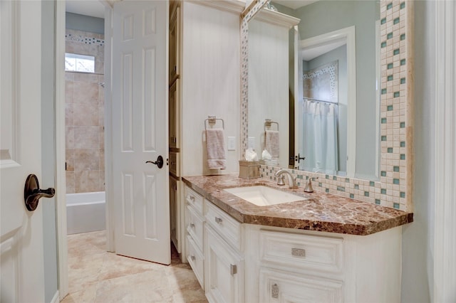 3207 Riviera Dr, Sugar Land, TX 77479 - bathroom featuring vanity, shower / bath combo, and decorative backsplash