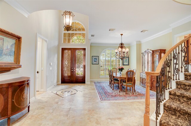 3207 Riviera Dr, Sugar Land, TX 77479 - foyer entrance with a chandelier, stairway, french doors, and ornamental molding