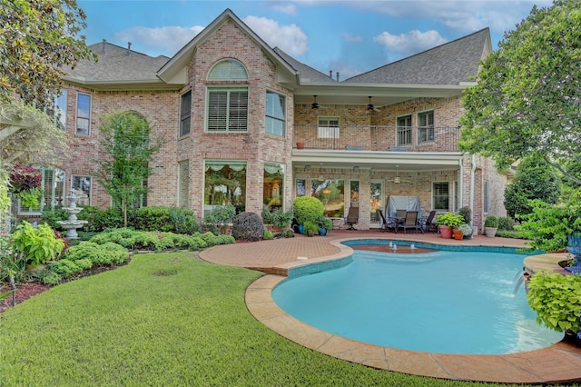 3207 Riviera Dr, Sugar Land, TX 77479 - back of property with ceiling fan, a patio, a balcony, and brick siding