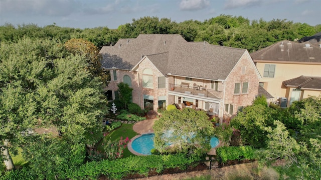 3207 Riviera Dr, Sugar Land, TX 77479 - back of property featuring a balcony and brick siding