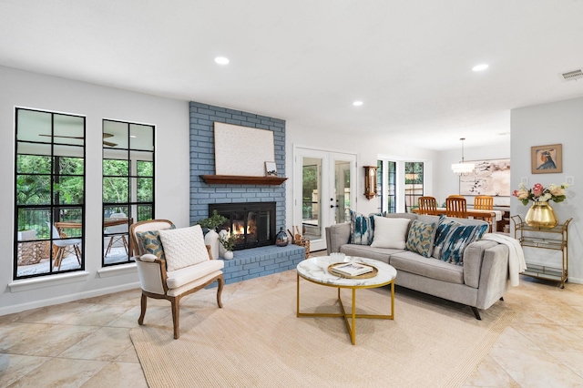 291 E Rainbow Ridge Cir, The Woodlands, TX 77381 - living room with recessed lighting, a brick fireplace, and french doors