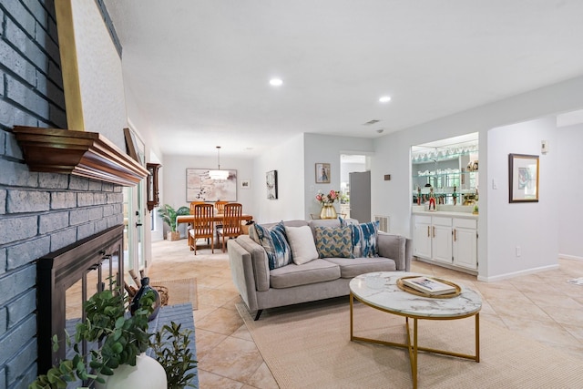 291 E Rainbow Ridge Cir, The Woodlands, TX 77381 - living room featuring a brick fireplace, light tile patterned floors, and recessed lighting