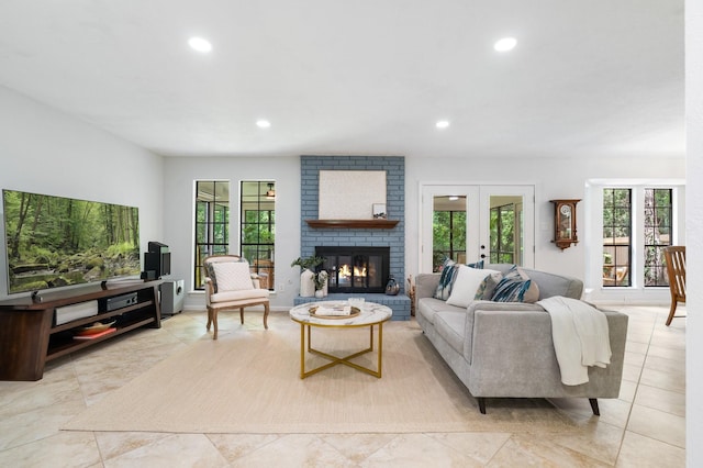 291 E Rainbow Ridge Cir, The Woodlands, TX 77381 - living room with recessed lighting, french doors, healthy amount of natural light, and a brick fireplace