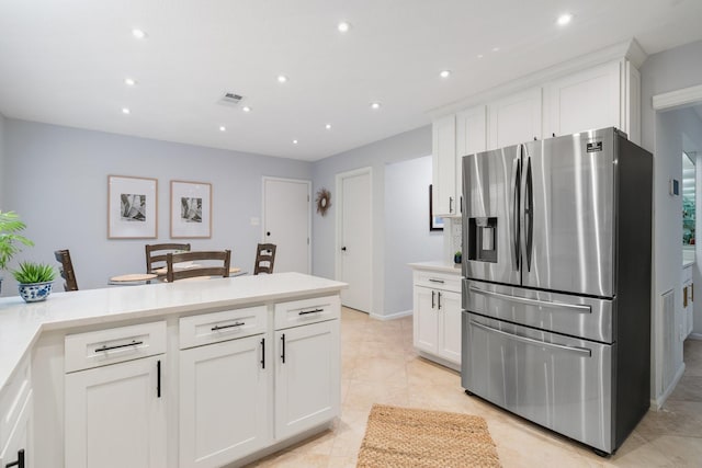 291 E Rainbow Ridge Cir, The Woodlands, TX 77381 - kitchen featuring stainless steel fridge, white cabinetry, recessed lighting, light countertops, and a peninsula
