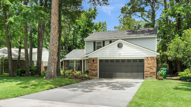 291 E Rainbow Ridge Cir, The Woodlands, TX 77381 - traditional-style house featuring brick siding, a garage, concrete driveway, and a front lawn