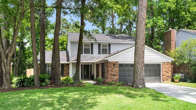 291 E Rainbow Ridge Cir, The Woodlands, TX 77381 - traditional-style house featuring an attached garage, brick siding, concrete driveway, and a front lawn