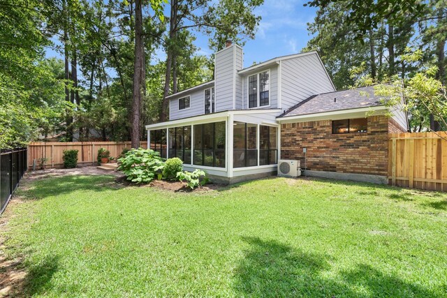 291 E Rainbow Ridge Cir, The Woodlands, TX 77381 - back of property featuring a sunroom, brick siding, a fenced backyard, a chimney, and a shingled roof