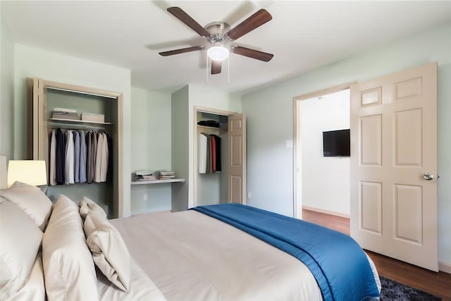 5402 Sheraton Oaks Dr, Houston, TX 77091 - bedroom with dark wood-type flooring, a ceiling fan, and two closets