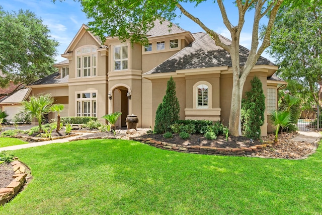 3602 Vashon Ln, Spring, TX 77388 - mediterranean / spanish home with stucco siding, a front lawn, and a shingled roof