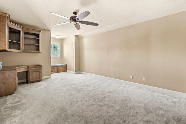 3602 Vashon Ln, Spring, TX 77388 - unfurnished living room featuring built in study area, ceiling fan, and light colored carpet
