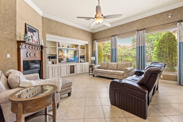 3602 Vashon Ln, Spring, TX 77388 - living room featuring light tile patterned floors, crown molding, a ceiling fan, built in shelves, and a glass covered fireplace