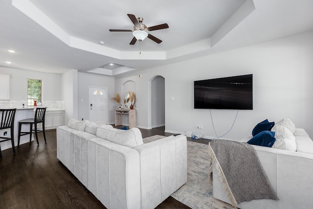 2018 Rd 660, Dayton, TX 77535 - living room featuring a tray ceiling, a ceiling fan, recessed lighting, arched walkways, and dark wood-style floors