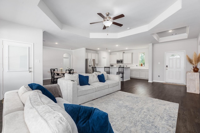 2018 Rd 660, Dayton, TX 77535 - living area featuring a tray ceiling, ceiling fan, dark wood finished floors, arched walkways, and recessed lighting
