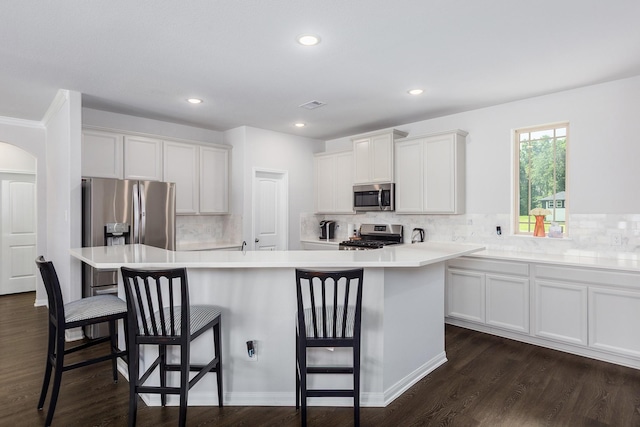 2018 Rd 660, Dayton, TX 77535 - kitchen with stainless steel appliances, decorative backsplash, a center island with sink, dark wood finished floors, and recessed lighting