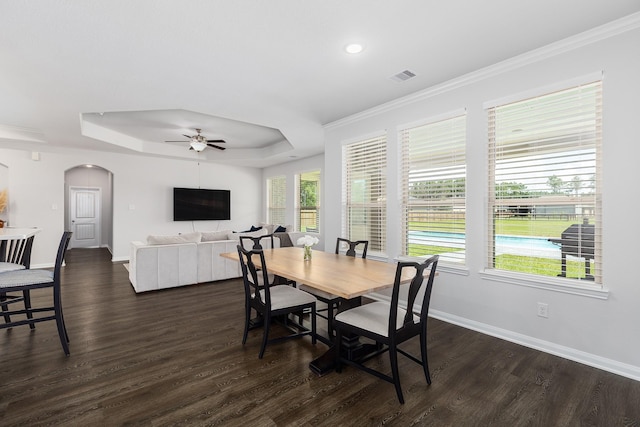 2018 Rd 660, Dayton, TX 77535 - dining area with arched walkways, a raised ceiling, a ceiling fan, dark wood-type flooring, and crown molding