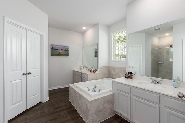 2018 Rd 660, Dayton, TX 77535 - bathroom featuring vanity, a shower stall, a garden tub, wood finished floors, and recessed lighting