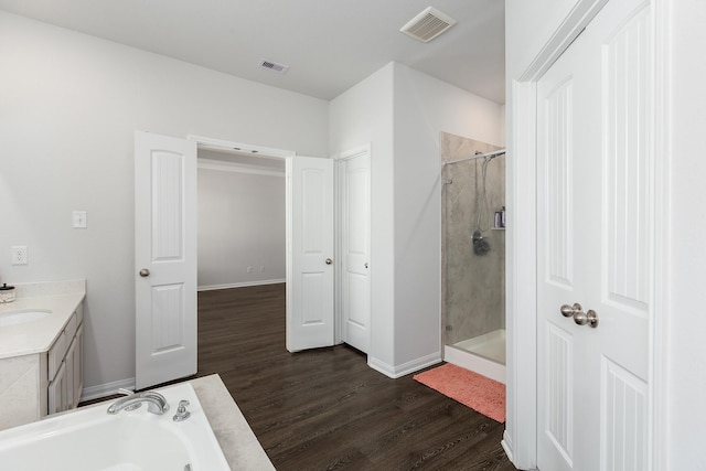 2018 Rd 660, Dayton, TX 77535 - bathroom with a stall shower, wood finished floors, a bath, and vanity